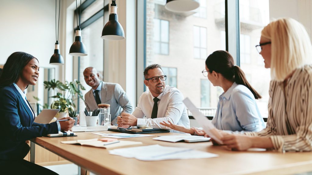 Business people around a table talking.