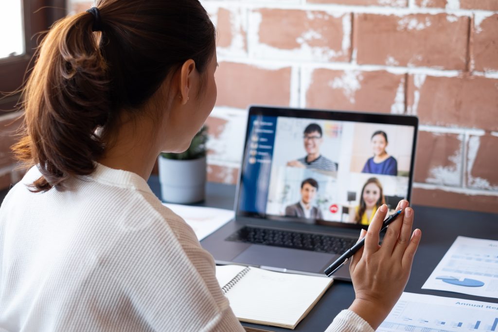 Girl on a videocall discussing the small business simulation SimVenture Classic