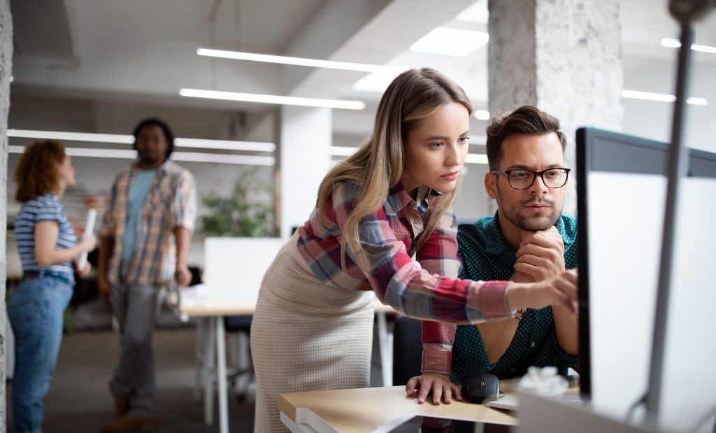 Group of business people, designers and software developers working as a team in office