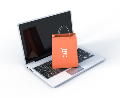 Laptop with bag on top of it having a shopping cart as a decoration symbol. Buy a SimVenture Classic personal software license.