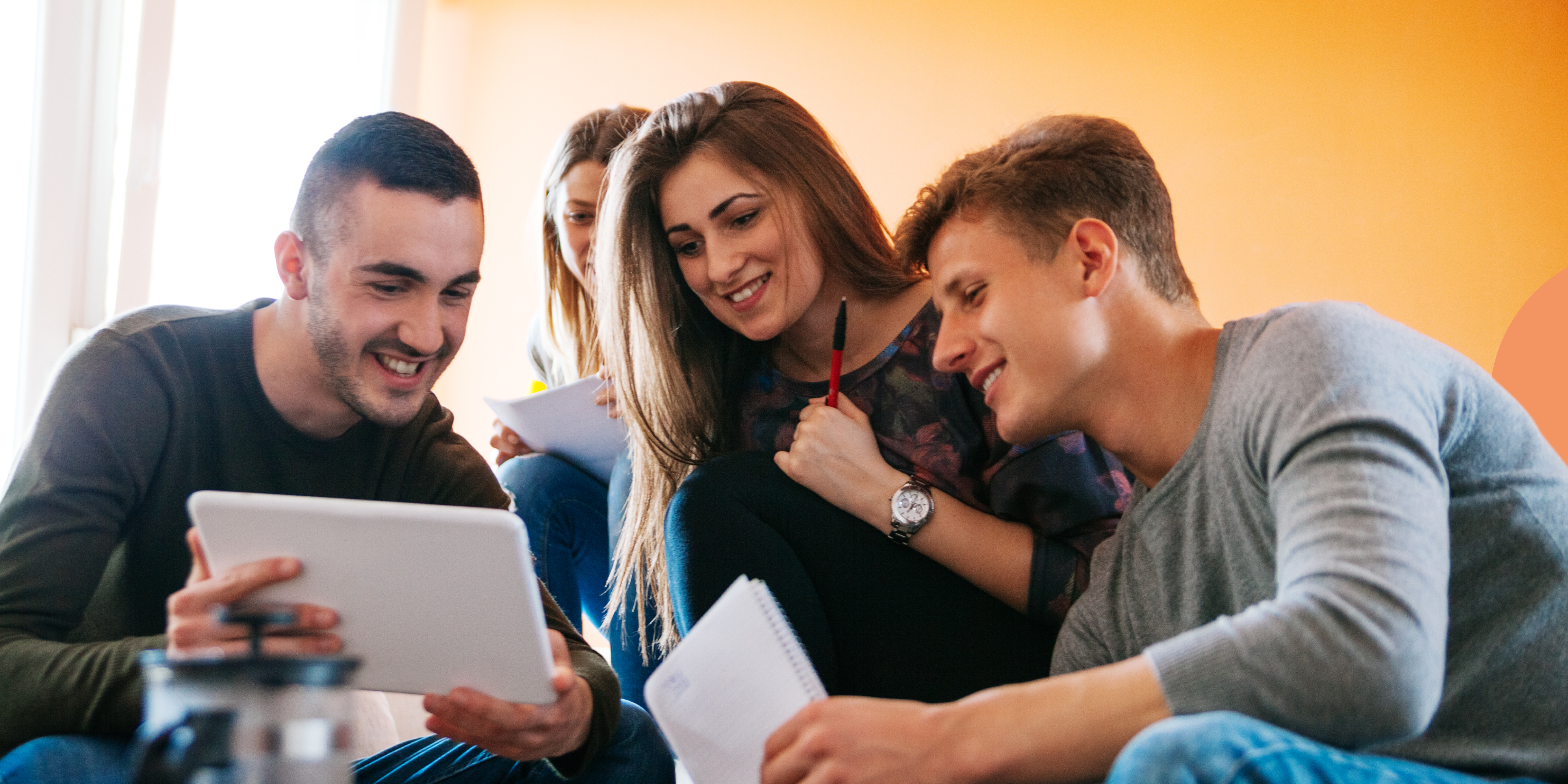 Hands-on learning in business education. Four university students using Validate on a tablet to help develop a startup idea for their entrepreneurship project. This is a great example of using experiential learning in business education.