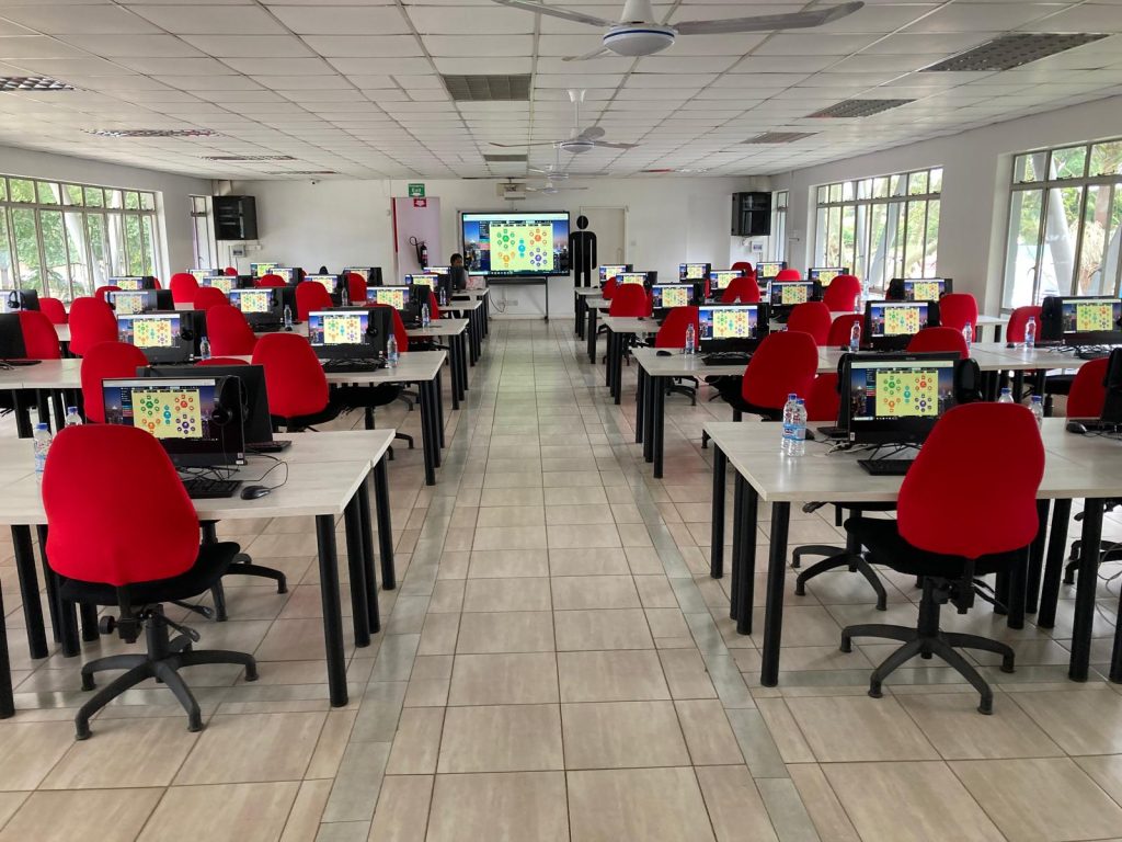 Evolution, the advanced online business simulation by SimVenture, on all computer screens in a school classroom.