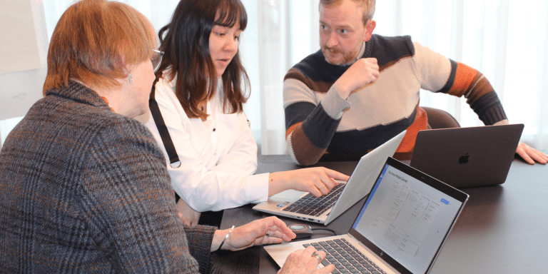 Teachers and educators discussing the startup ideas platform Validate for student assessment