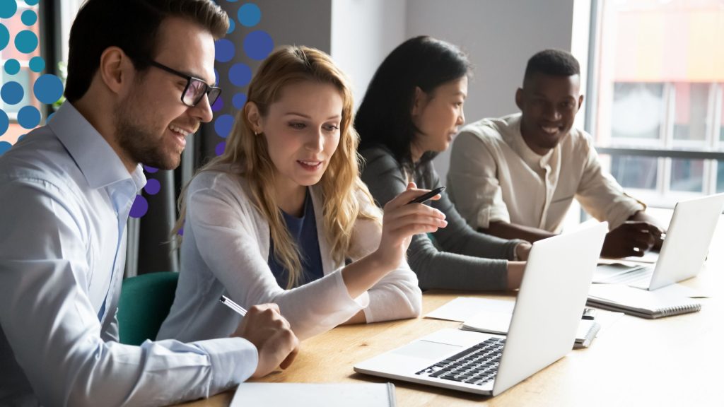 Business people working in teams using the business simulation, Evolution, developed by SimVenture.