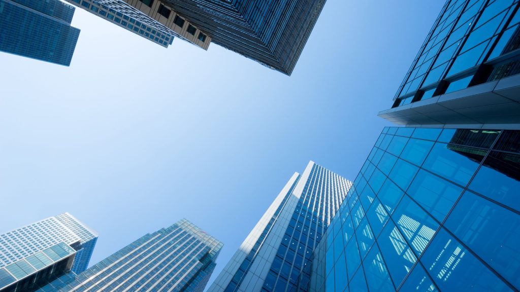 Looking up at skyscrapers in a big city representing large business and the need for corporate training.